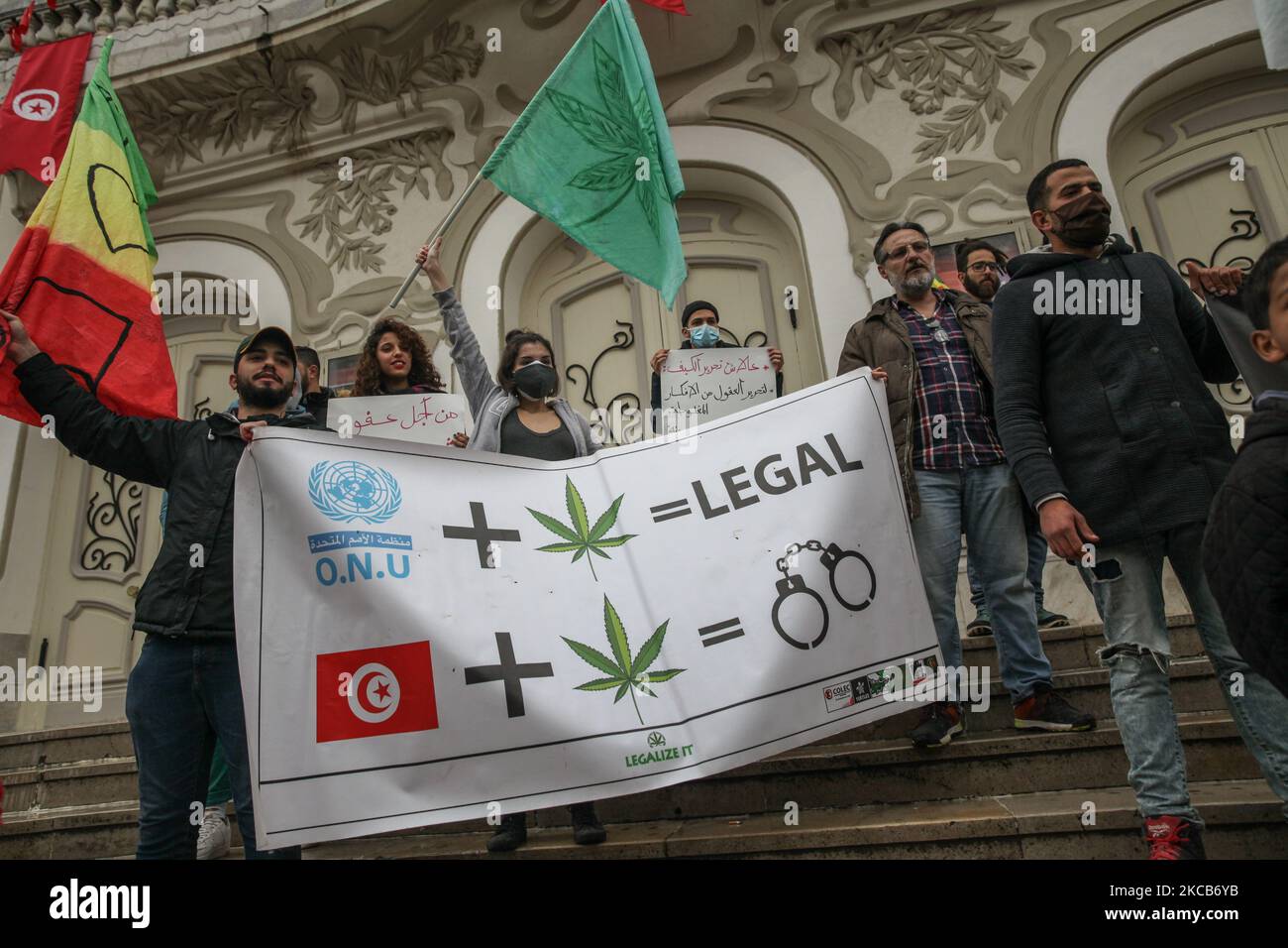 Protesters wave flags as they hold a banner with a drawing of cannabis leaf, handcuffs and the United Nations watermark, and that reads Legal, during a demonstration held on Habib Bourguiba Avenue in Tunis, Tunisia, on March 20, 2021, where demonstrators rallied to call for the decriminalisation and legalization of cannabis use and the liberalisation of its commercialisation. The young demonstrators also demanded the suspension of the application of law 52 on narcotics which is regarded as repressive, and asked for a pardon for all those detained for drug use. (Photo by Chedly Ben Ibrahim/NurP Stock Photo