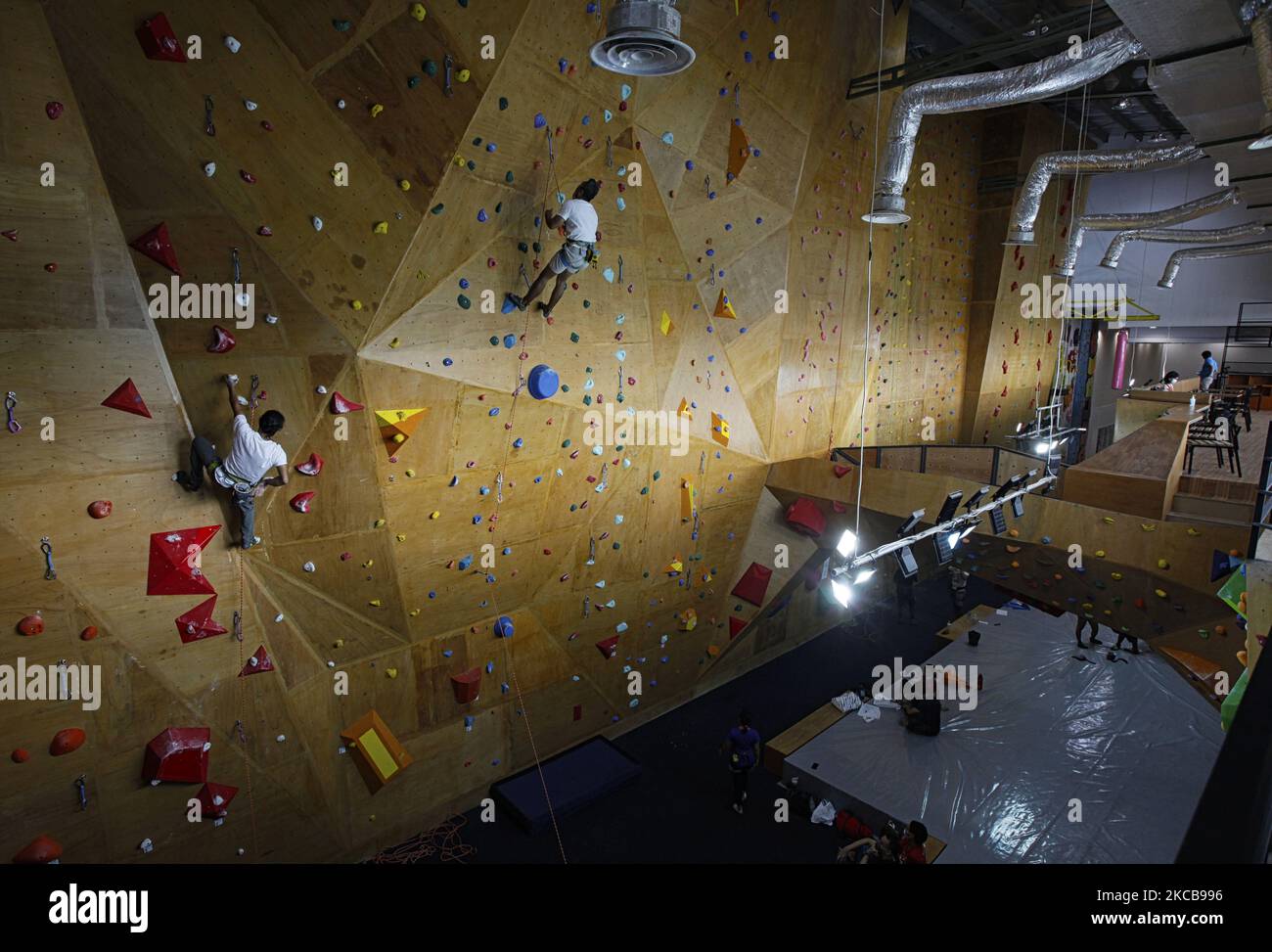 Climber climbs on the artificial wall during a training session at