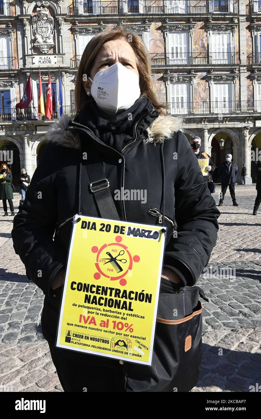 Professionals from the hairdressing and aesthetic sector gather with banners to demand the reduction of VAT to 10 percent in the main square, in Madrid (Spain), on March 22, 2021. (Photo by Oscar Gonzalez/NurPhoto) Stock Photo