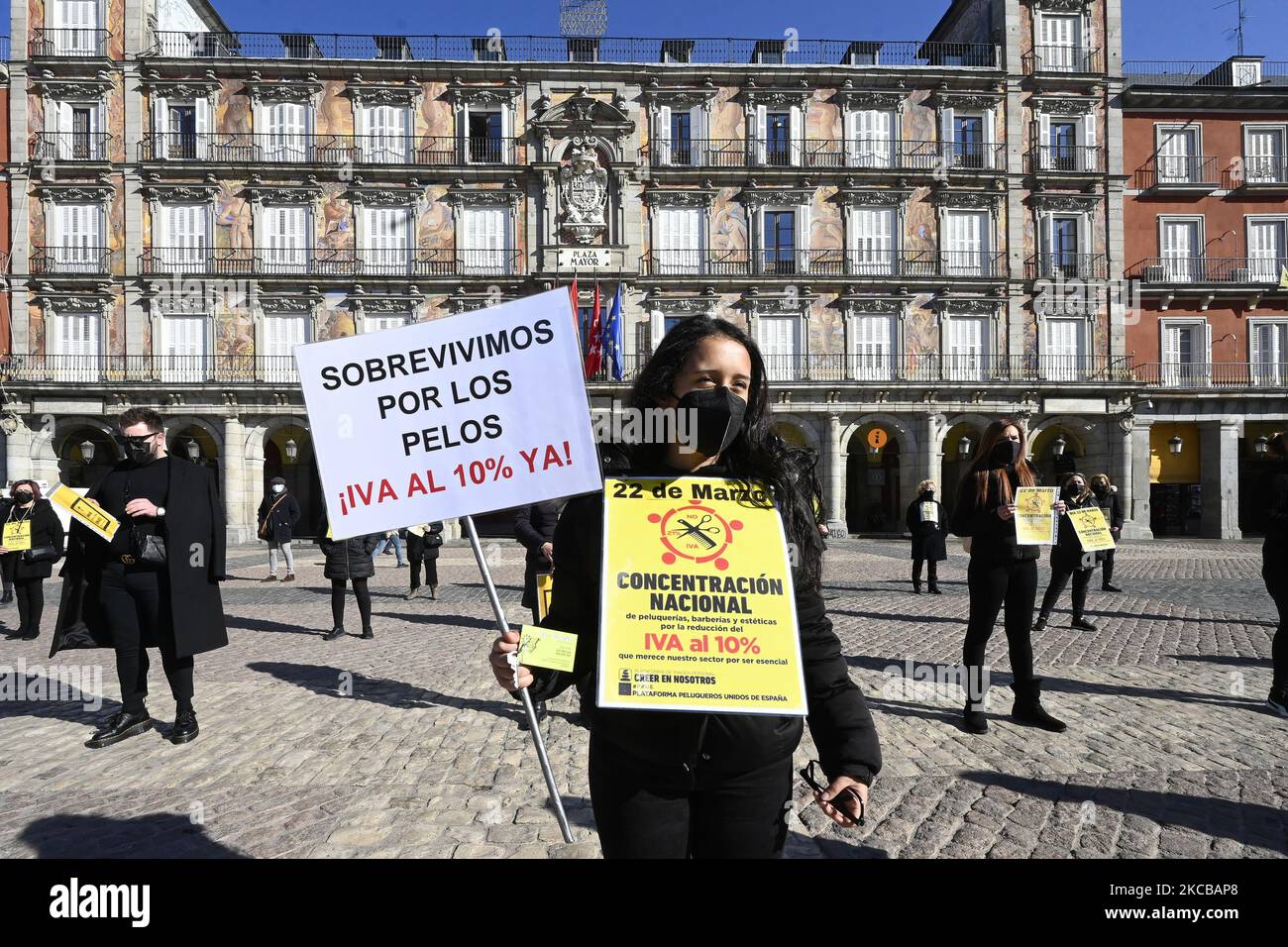 Professionals from the hairdressing and aesthetic sector gather with banners to demand the reduction of VAT to 10 percent in the main square, in Madrid (Spain), on March 22, 2021. (Photo by Oscar Gonzalez/NurPhoto) Stock Photo