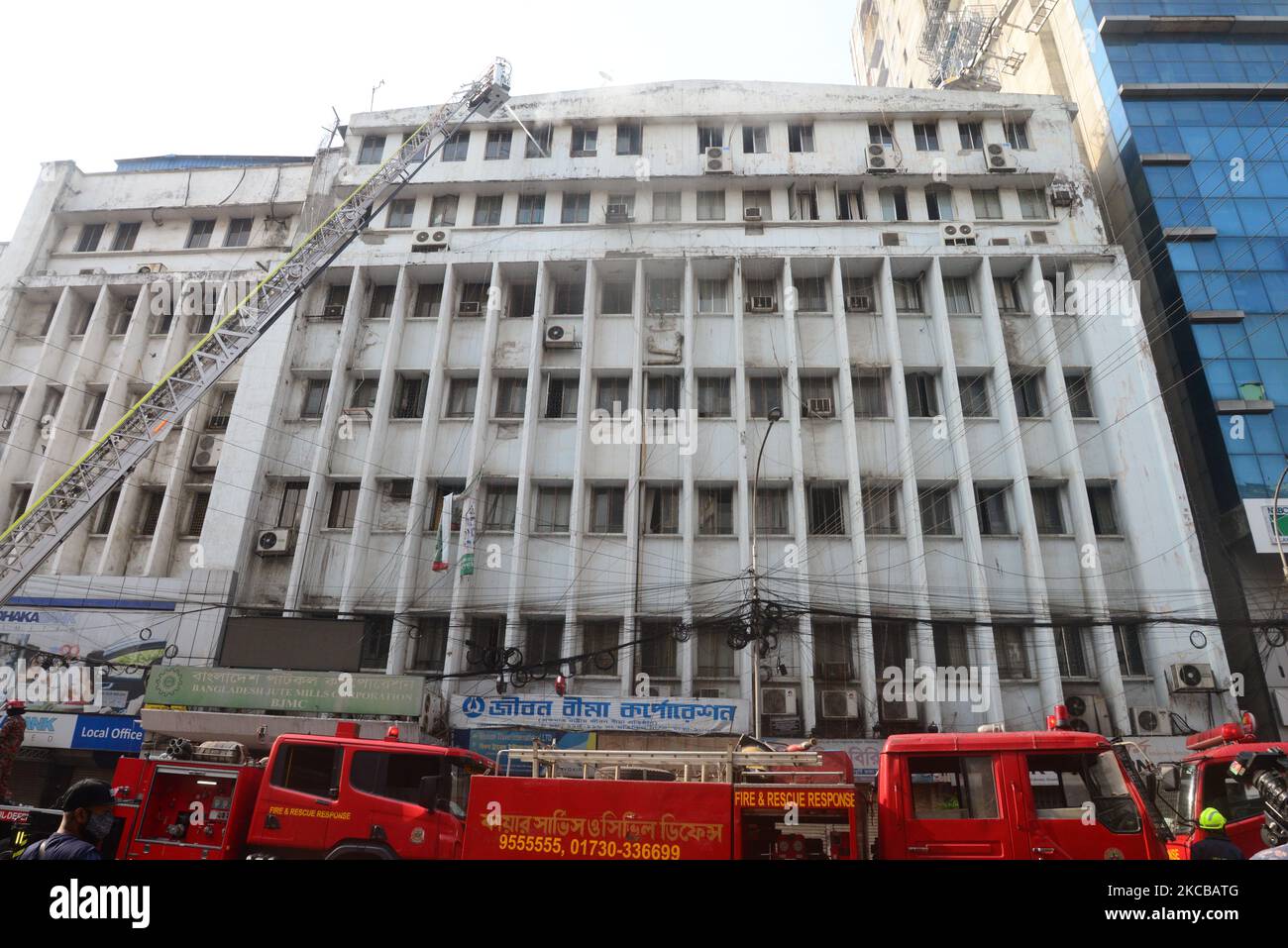 Firefighters try to extinguish a fire in a Bangladesh June Mills