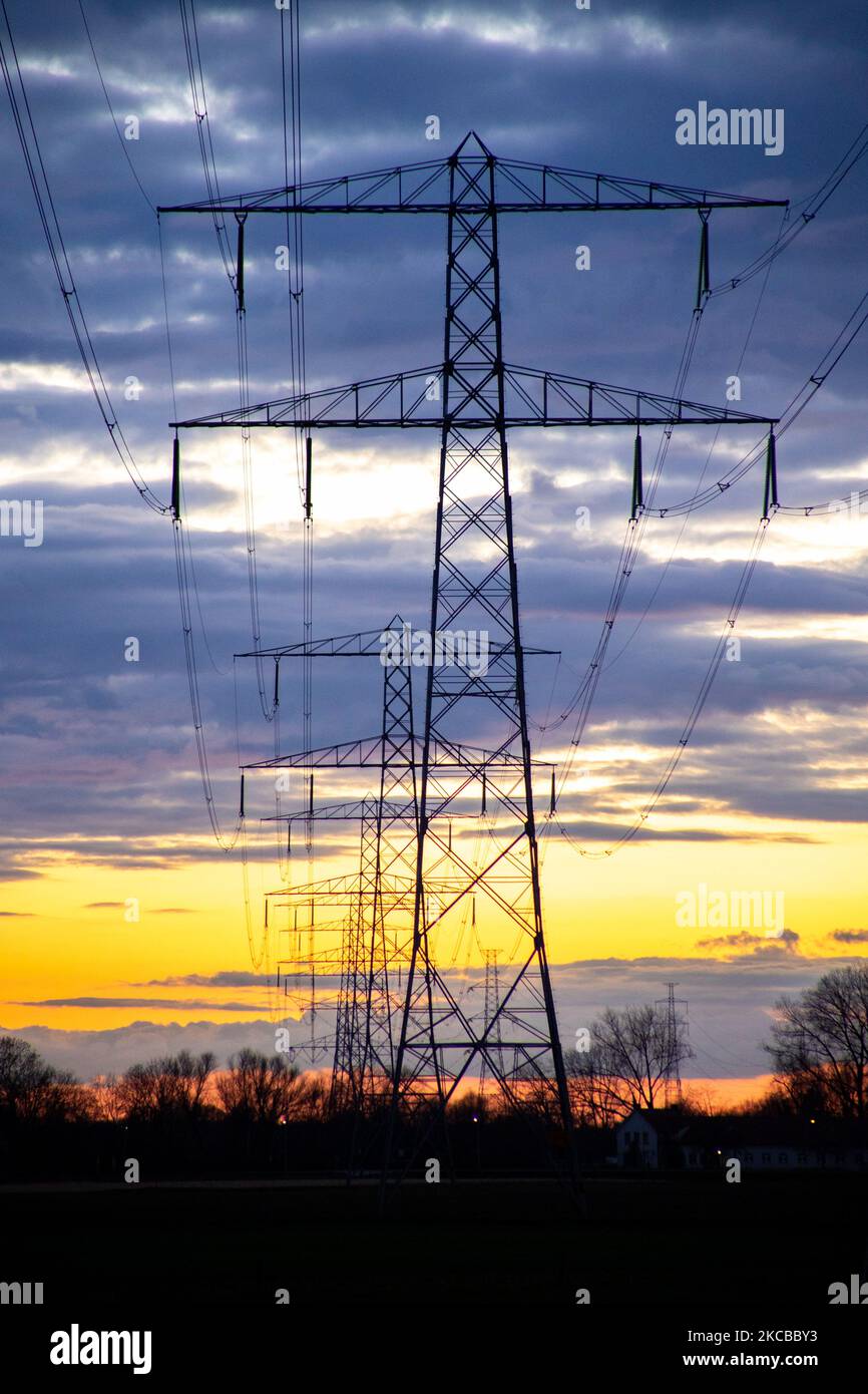 High voltage electricity poles during magic hour. The metal towers as