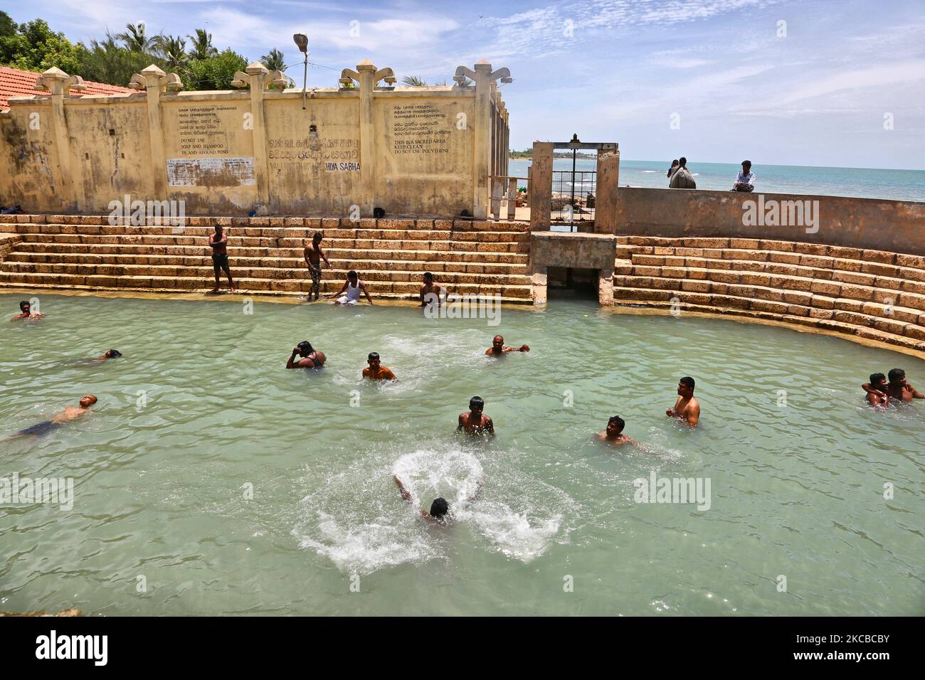 Hindu devotees bathe in the Keerimalai Sacred Hot Springs on the
