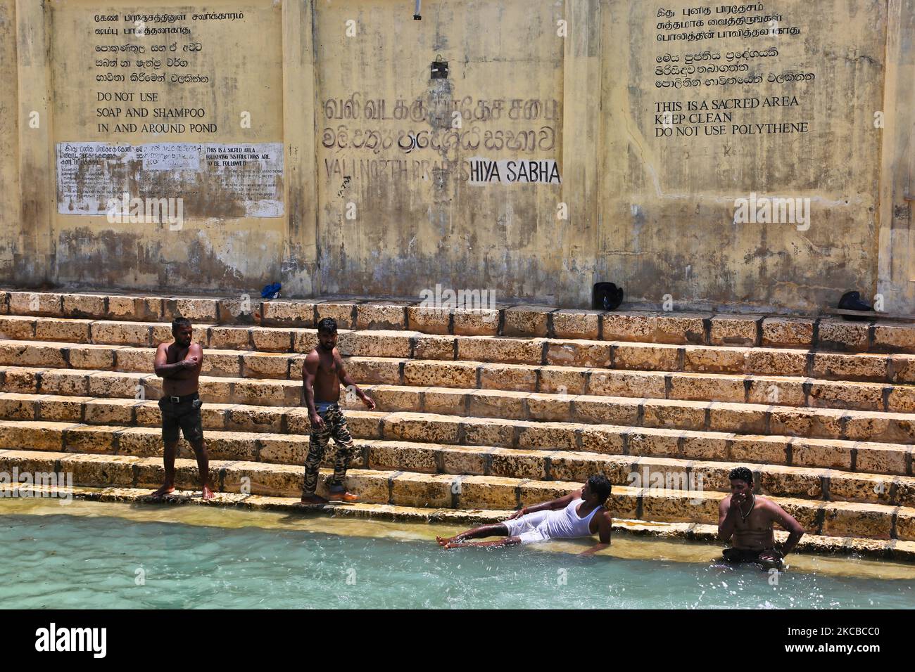 Hindu devotees bathe in the Keerimalai Sacred Hot Springs on the