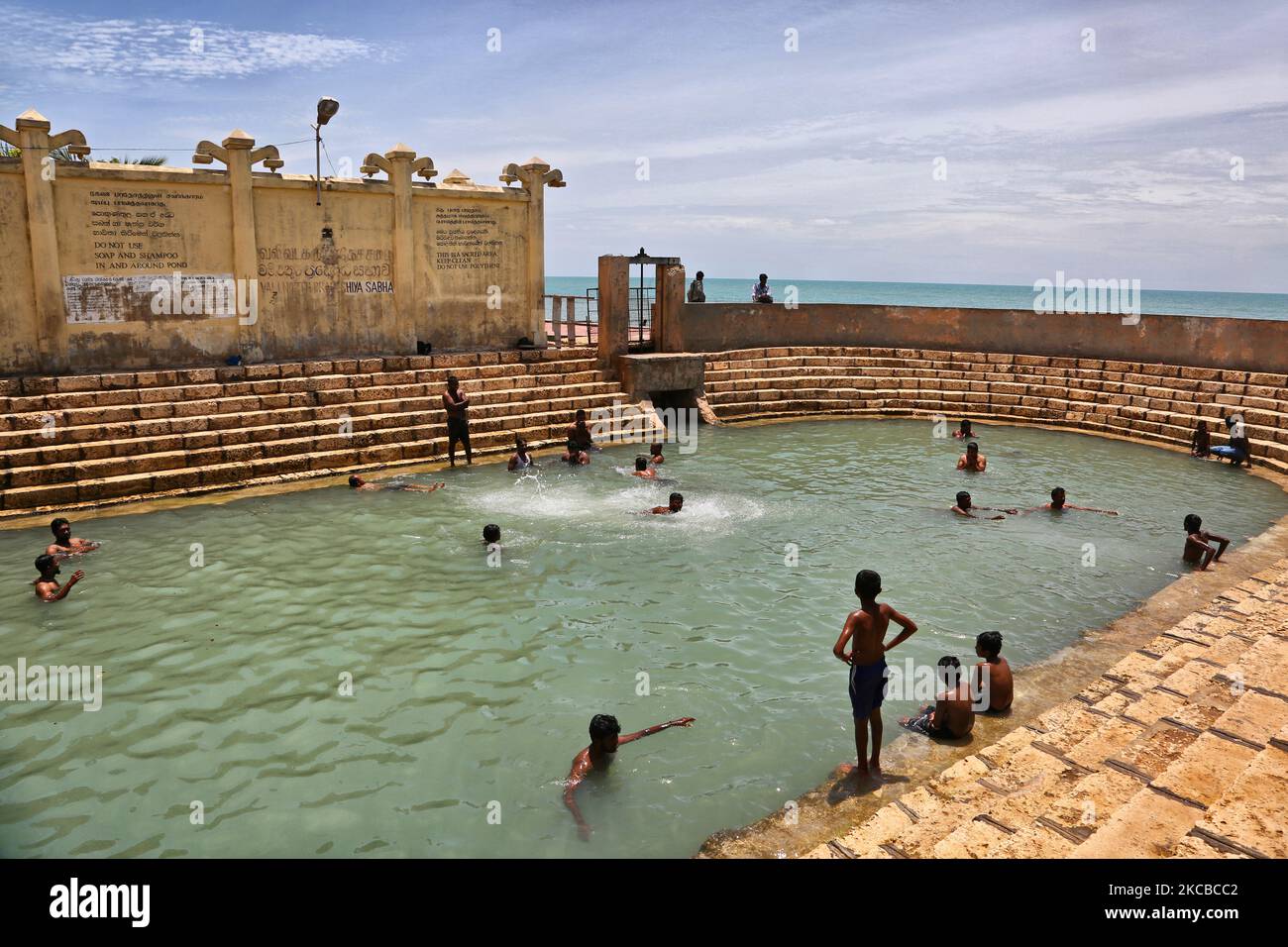 Hindu devotees bathe in the Keerimalai Sacred Hot Springs on the