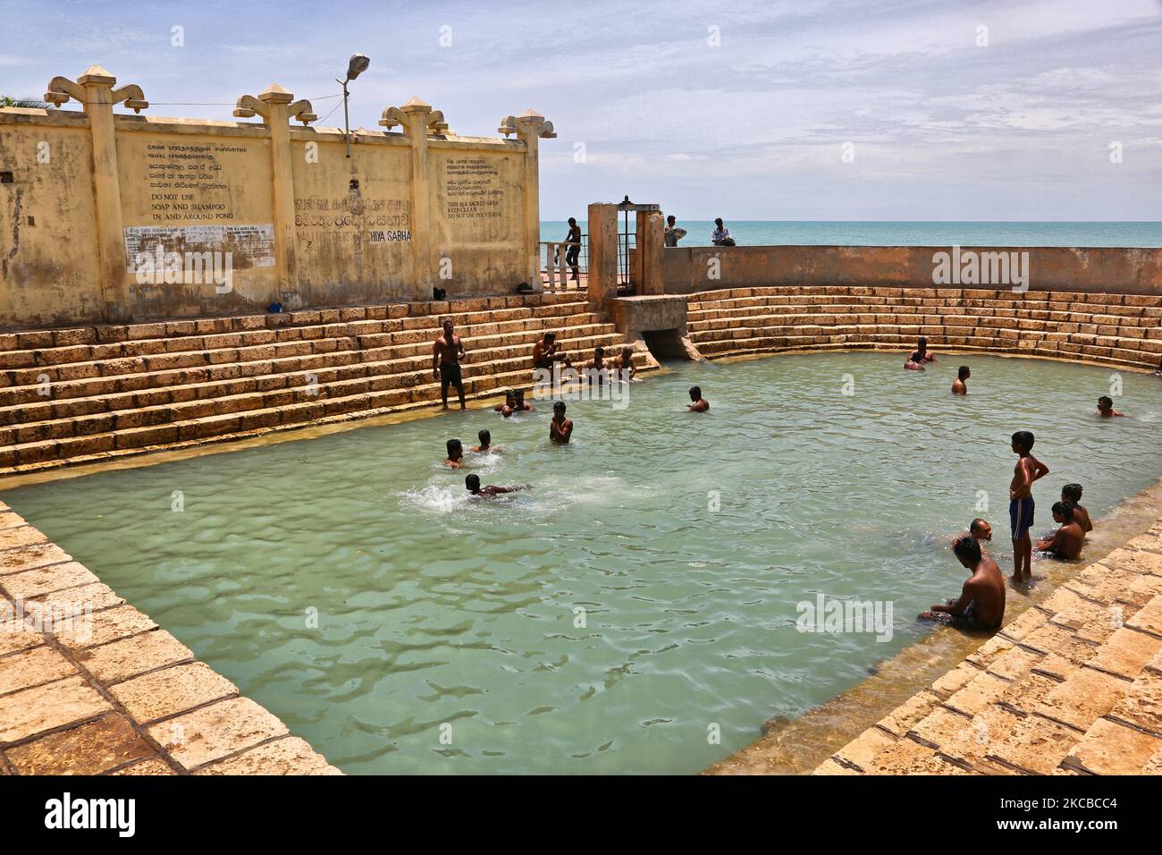 Hindu devotees bathe in the Keerimalai Sacred Hot Springs on the