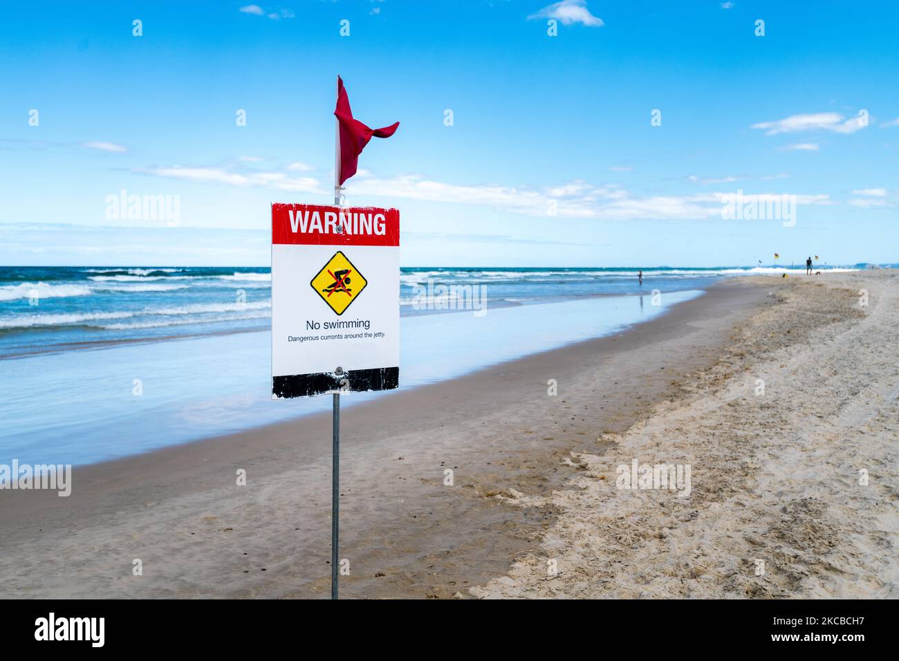 Warning No Swimming Sign on Beach Red Flag Stock Photo