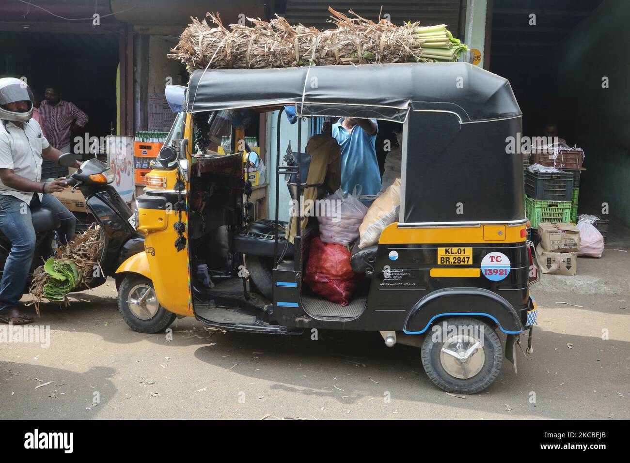 An autorickshaw is loaded with fruits and vegetables at the Chalai