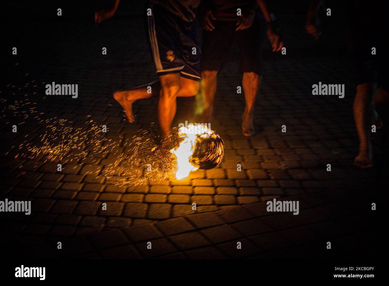 Indonesian muslims play fire football, a game played with a fire ball ...