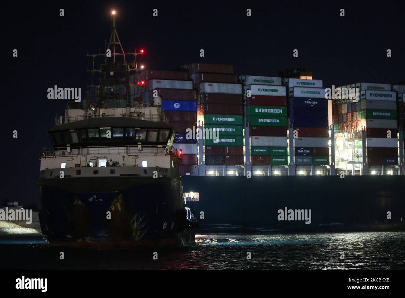 A general view of ''Ever Given'', a container ship which is currently stuck in the Suez canal, during a tugging attempt to re-float it, in Suez, Egypt, on March 27, 2021. The state-run Suez Canal Authority (SCA) announced that nearly 17,000 cubic meters of sand have been dredged around the ship after navigation through the Suez Canal has been temporarily stoped which has been wedged diagonally across the span of the canal about six kilometres north of the Suez Canal's entrance by the Red Sea port city of Suez since March 23, blocking the waterway in both directions (Photo by Ziad Ahmed/NurPhot Stock Photo