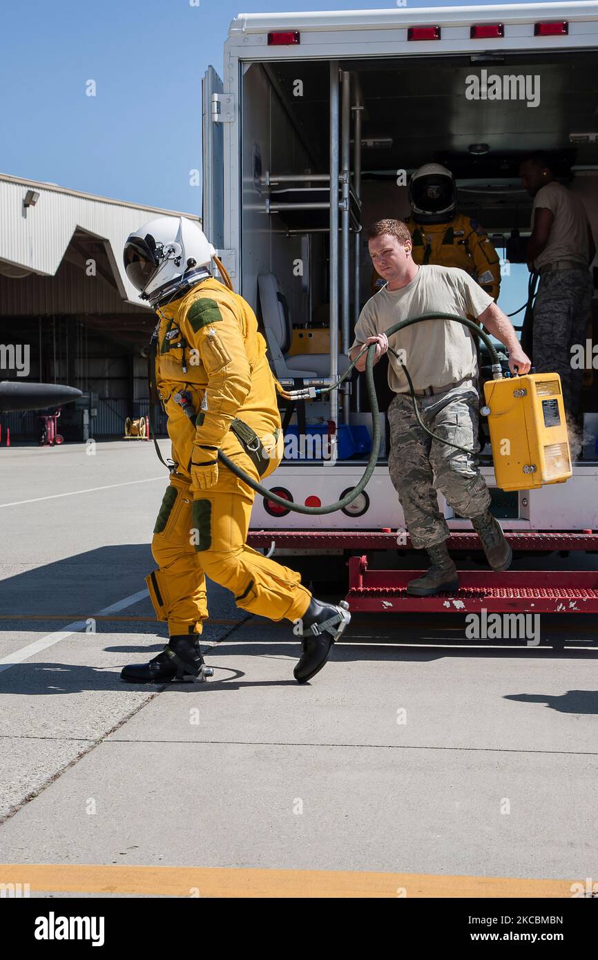 Two pilots dressed in high-altitude pressure suits depart their crew ...