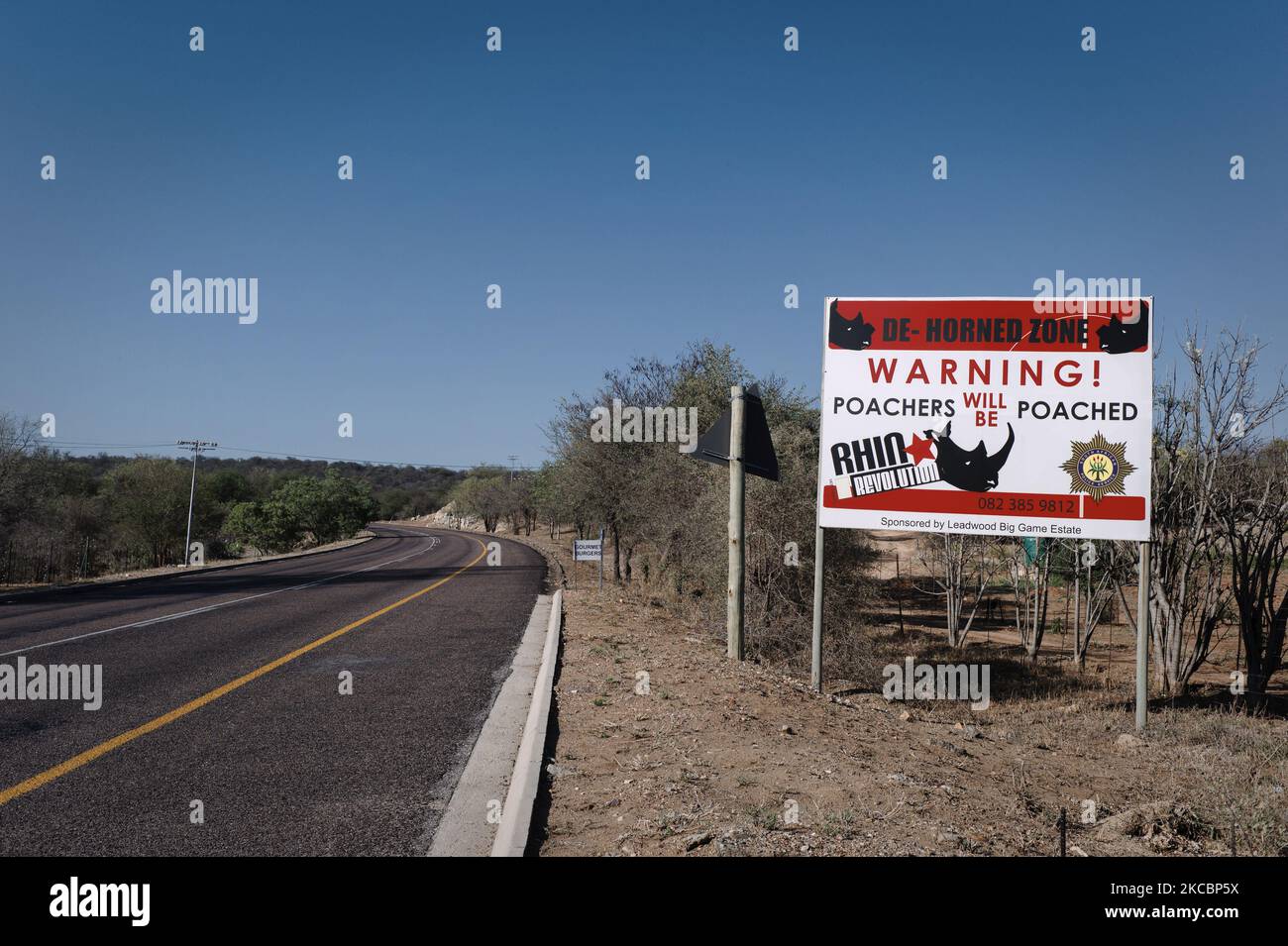 A sign on the side of the road warns poachers near the Balule reserve on November 17, 2018 in South Africa. The Black Mambas Anti-Poaching Unit was founded in 2013 by Transfrontier Africa NPC to protect the Olifants West Region of Balule Nature Reserve. (Photo by Matthieu Alexandre/NurPhoto) Stock Photo