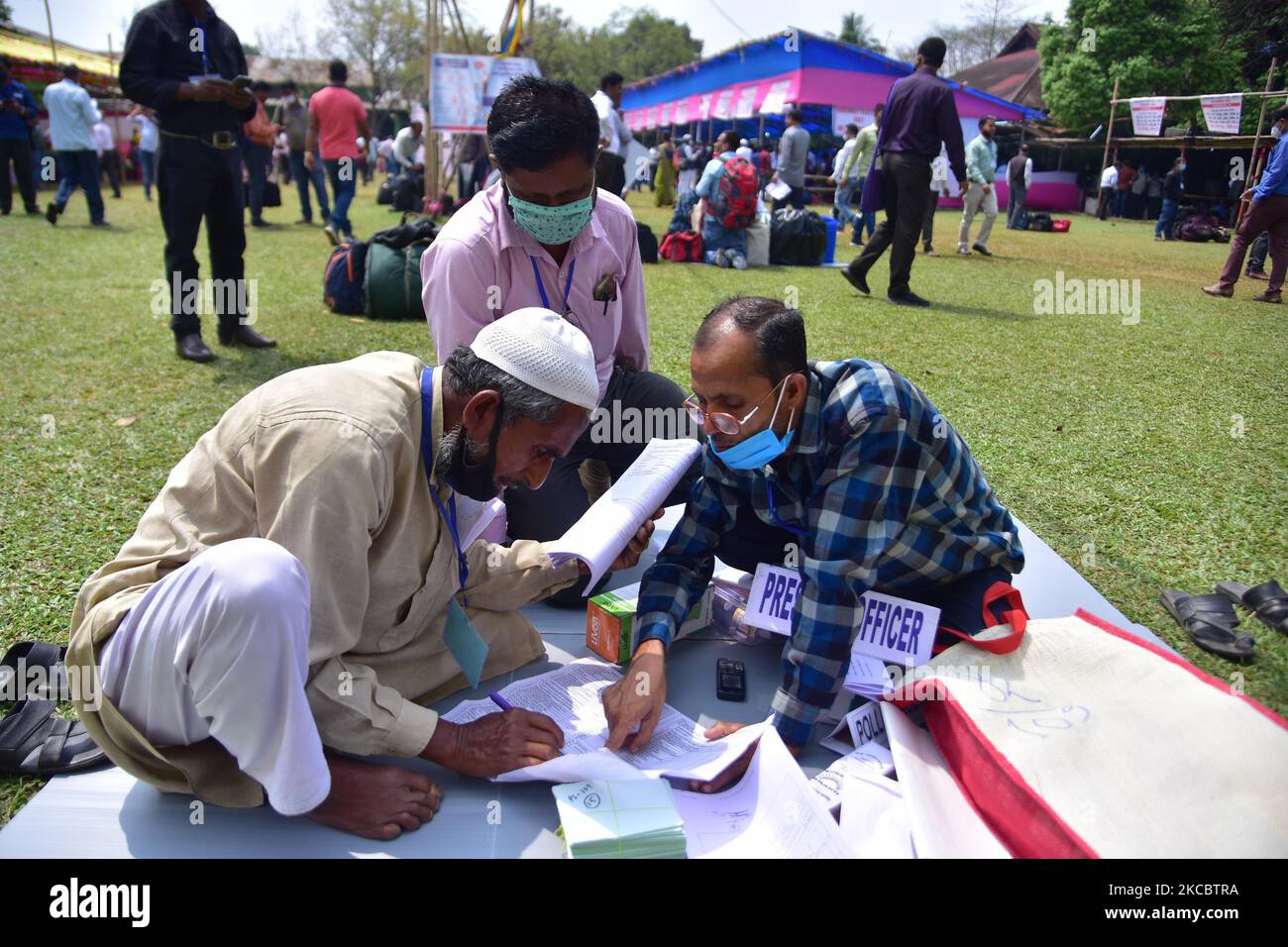 Polling officers check the election materials after collecting them