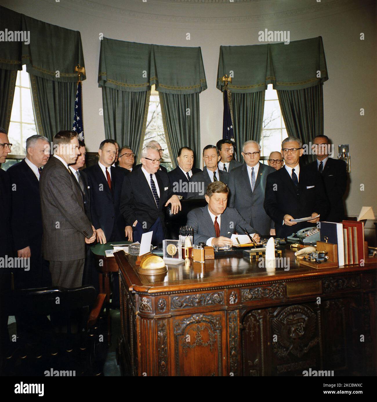 President John F. Kennedy signing the Manpower Development and Training Act of 1962. Stock Photo