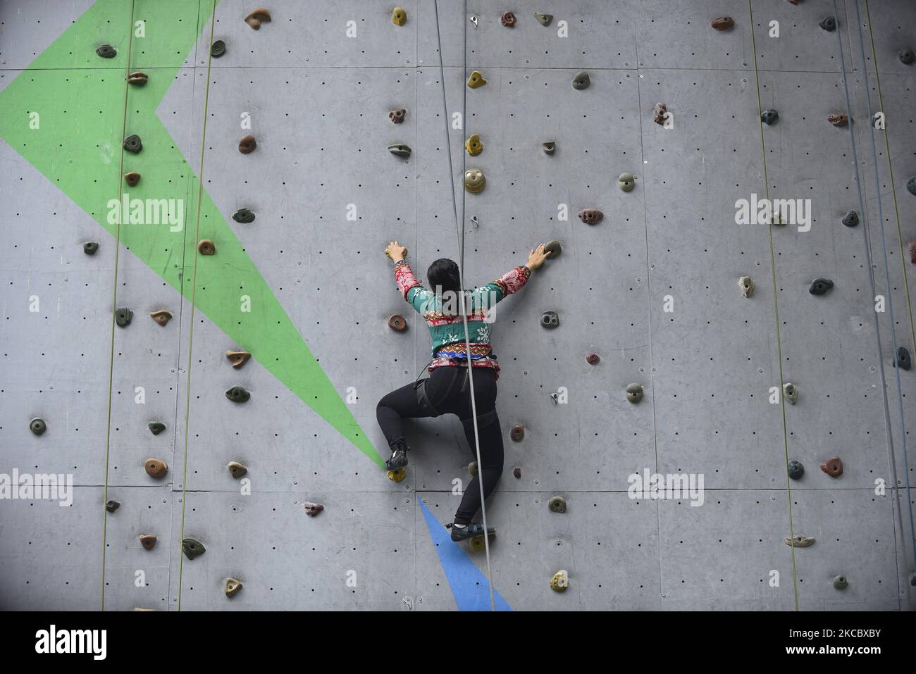 A visually impaired girl tries to climb wall in Astrek Climbing wall at