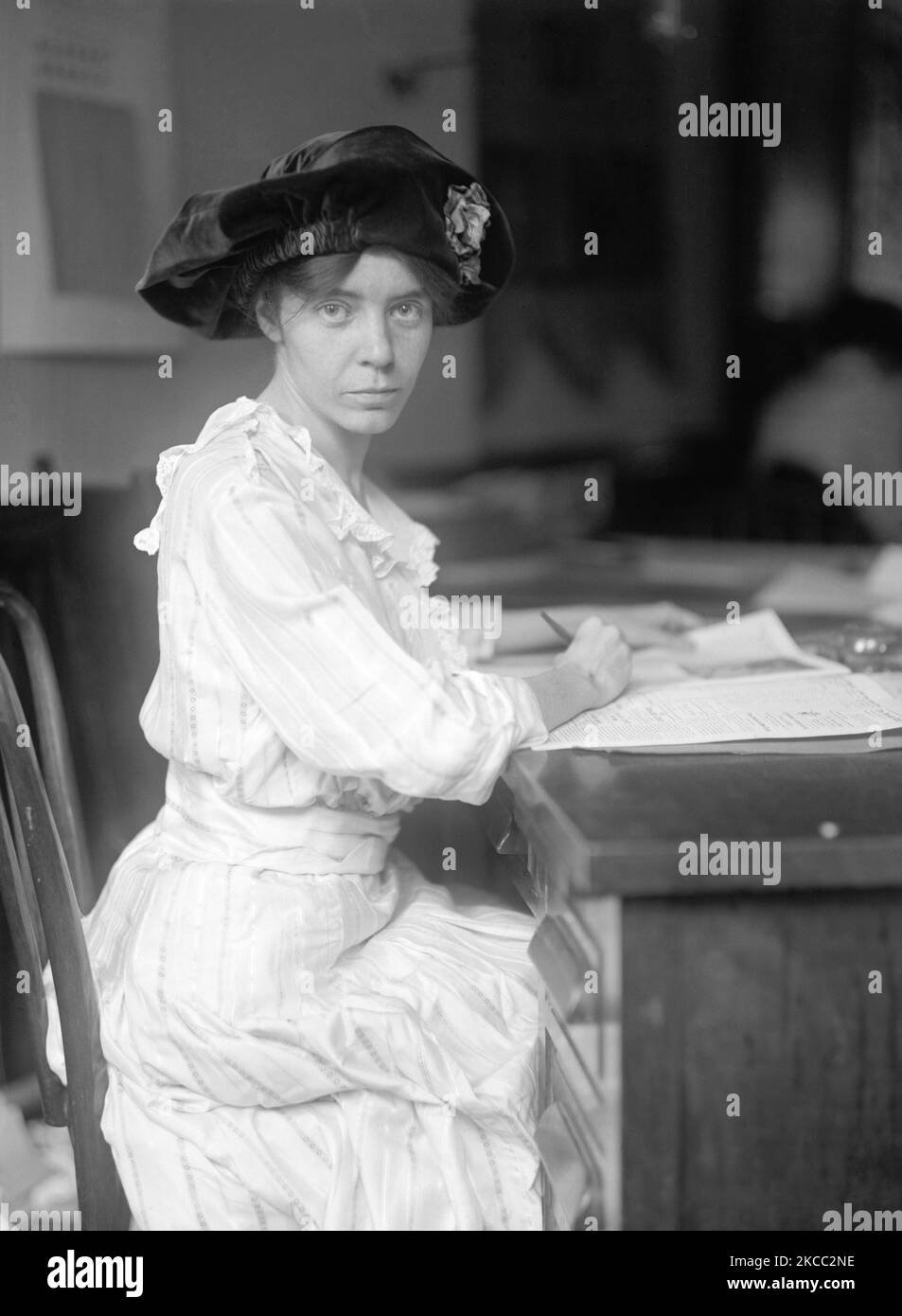 Alice Paul writing at a desk in 1915. Stock Photo
