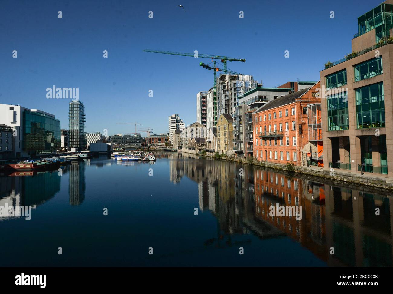 A general view of the Grand Canal Docks, an enclosed docking area that accomodate barges, with Boland's Mill and new Google office buildings (on right) seen in Dublin during level 5 COVID-19 lockdown. On Saturday, April 3, 2021, in Dublin, Ireland. (Photo by Artur Widak/NurPhoto) Stock Photo