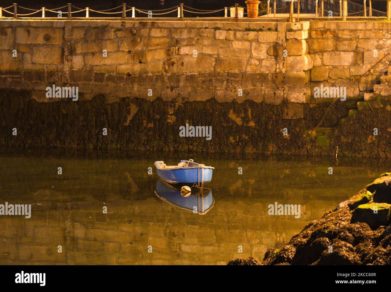 A reflection of a small dinghy fishing boat seen Dun Laoghaire marina