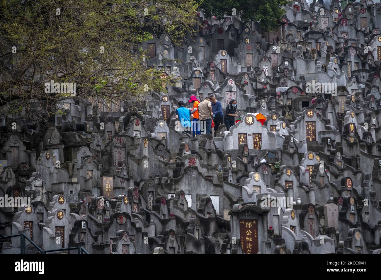 People pay respect at a cemetery during the Ching Ming Festival, also
