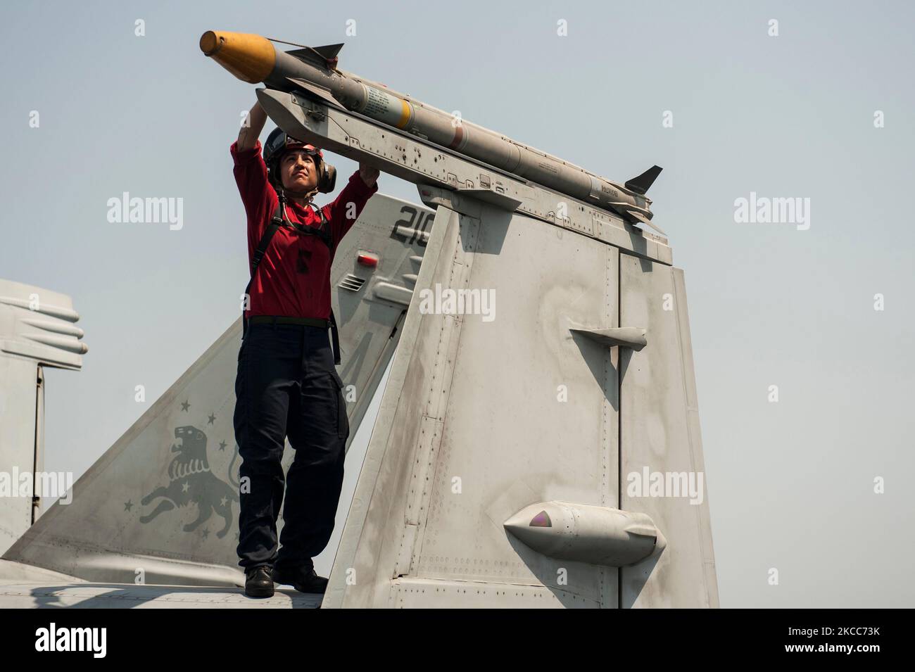 Aviation Ordnanceman inspects an AIM 9X missile on an F/A-18F Super Hornet. Stock Photo
