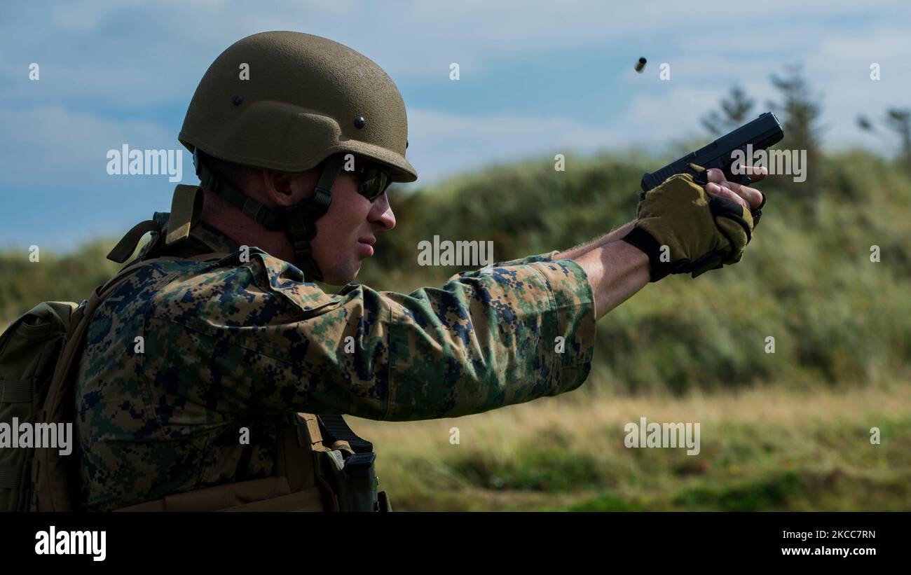 A member of the U.S. Marine Corps Shooting Team fires a round at a target. Stock Photo