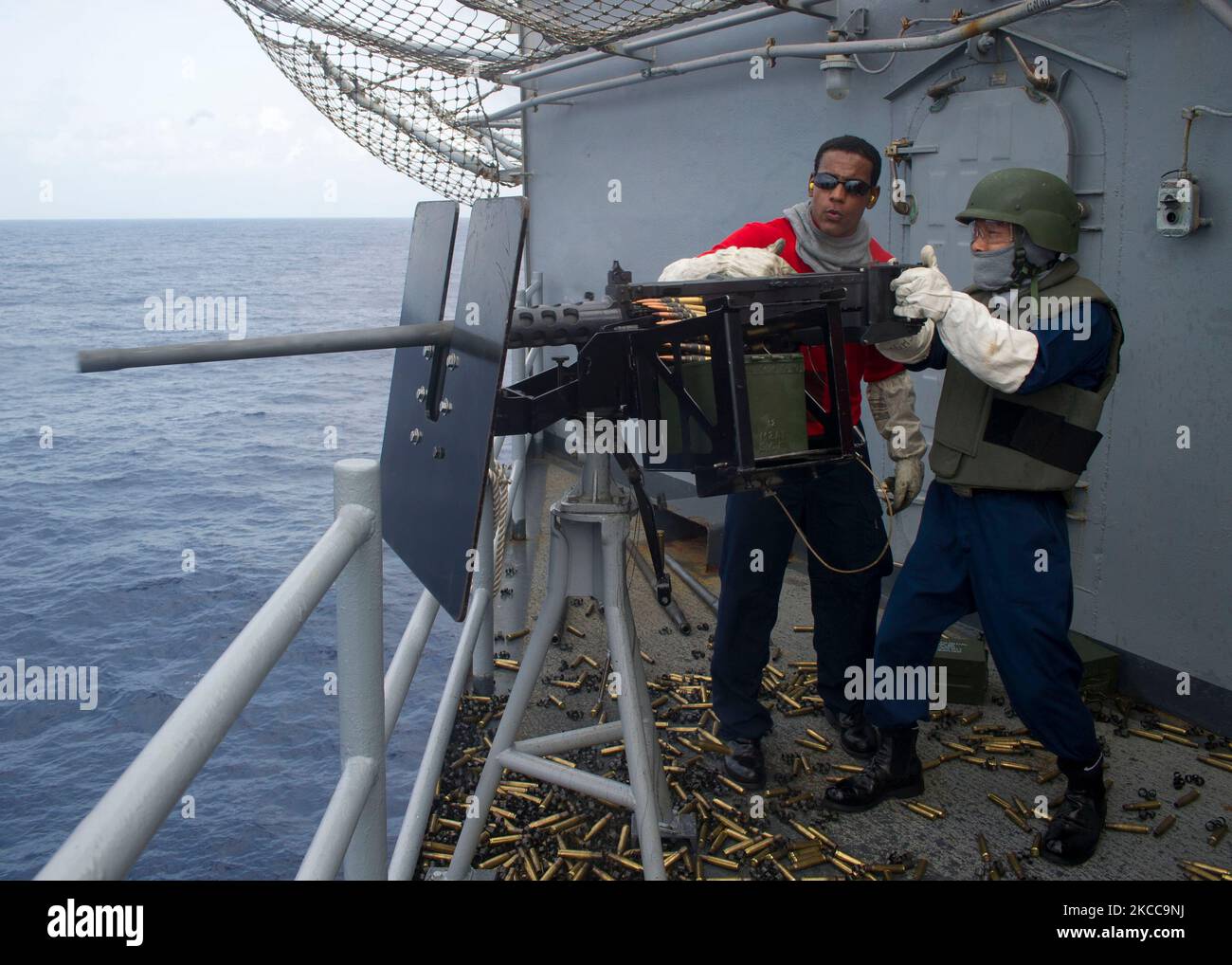 A .50-caliber machine gun is fired aboard USS Peleliu. Stock Photo