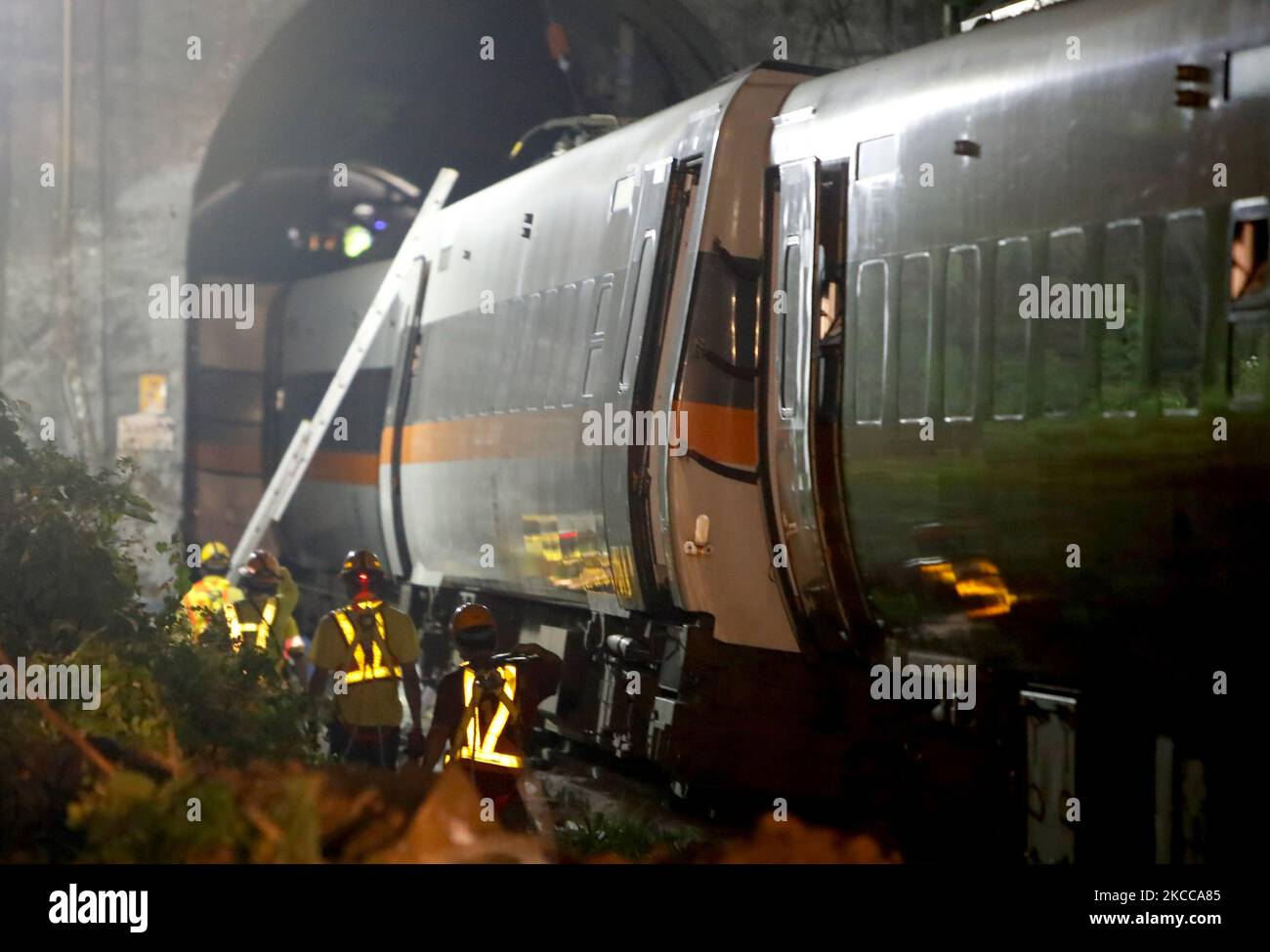 Police officers remove belongings from and conduct investigations at a scene where a train carrying 490 people has been derailed, in Hualien, Taiwan 3 April 2021. The accident has killed at least 50 people, injured dozens and severely damaged the railway. (Photo by Ceng Shou Yi/NurPhoto) Stock Photo