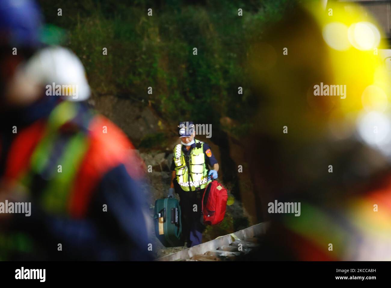Police officers remove belongings from and conduct investigations at a scene where a train carrying 490 people has been derailed, in Hualien, Taiwan 3 April 2021. The accident has killed at least 50 people, injured dozens and severely damaged the railway. (Photo by Ceng Shou Yi/NurPhoto) Stock Photo