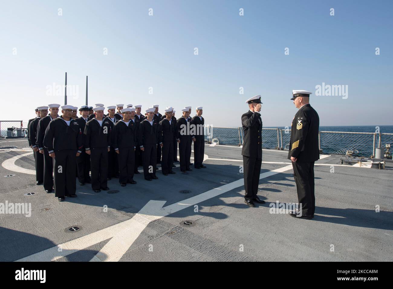 Sailors conduct a dress blue uniform inspection aboard USS Ross. Stock Photo