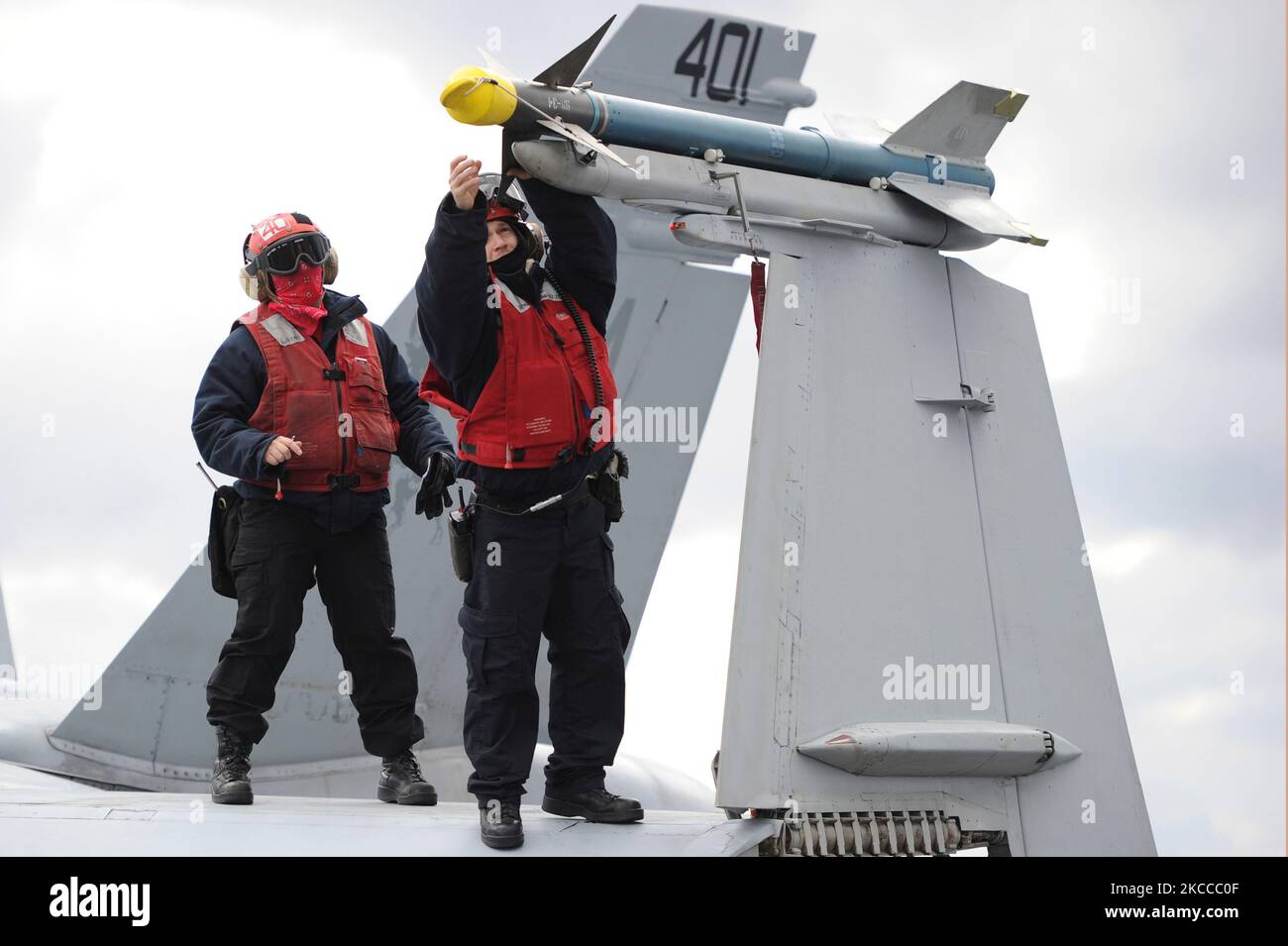 Aviation Ordanancemen verify serial numbers on an FA-18C Hornet. Stock Photo