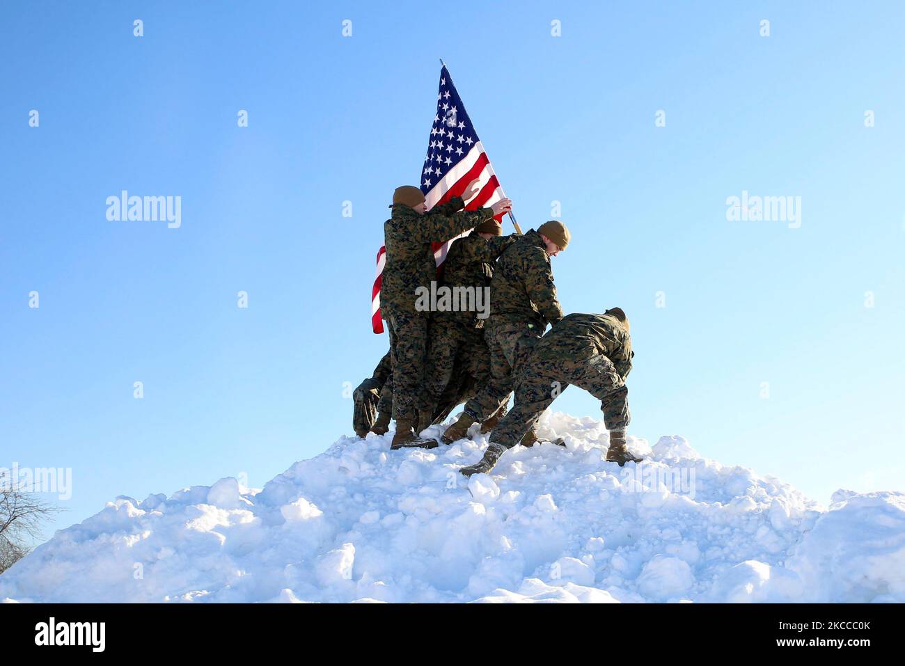 U.S. Marines recreate the flag raising on Iwo Jima duringa major snowfall in Illinois. Stock Photo