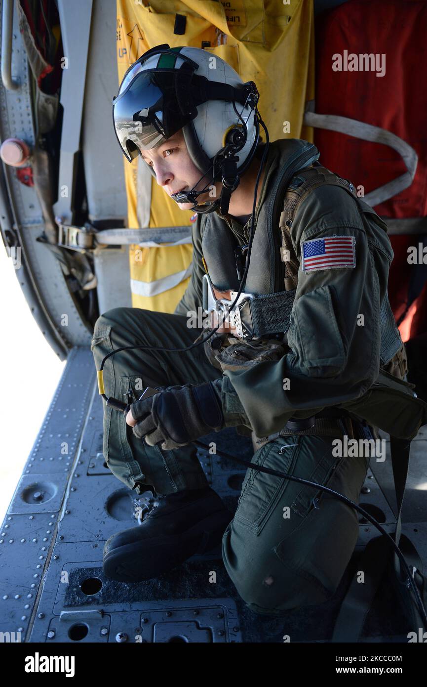 Naval Air Crewman conducts lookout procedures. Stock Photo