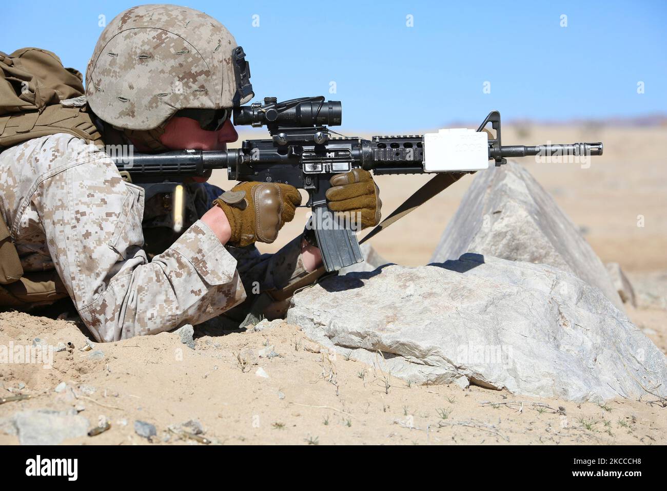 A U.S. Marine fires rounds downrange with the M4 Modular Weapon System. Stock Photo