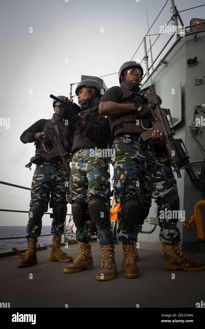 Nigerian Navy boarding team members maintain security aboard a ship. Stock Photo
