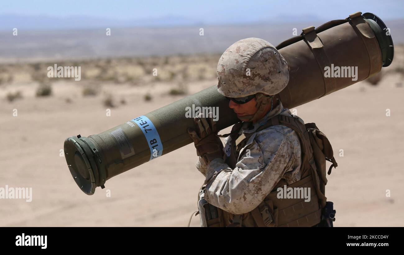 U.S. Marine carries a tube-launched, optically-tracked, wire-guided missile. Stock Photo