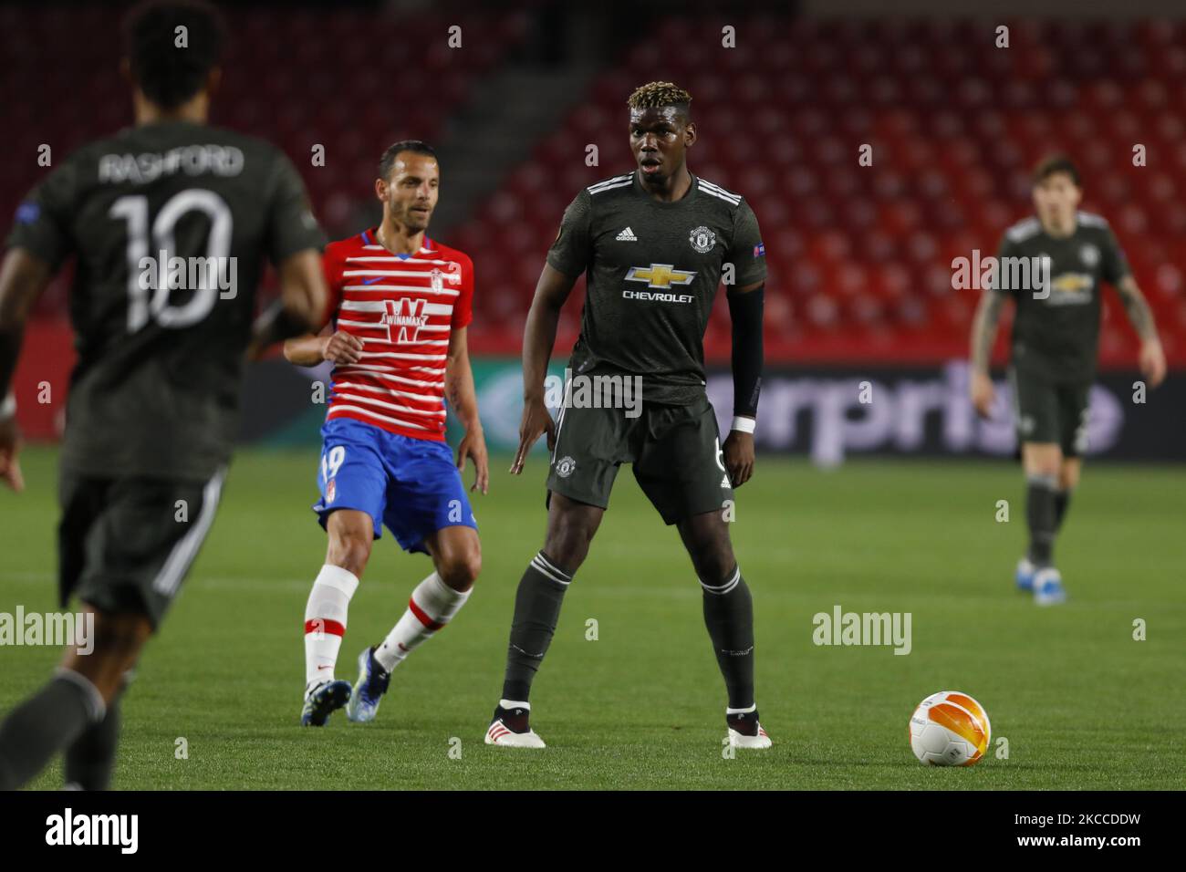 Paul Pogba, of Manchester United and Roberto Soldado, of Granada CF during the UEFA Europa League Quarter Final leg one match between Granada CF and Manchester United at Nuevo Los Carmenes Stadium on April 8, 2021 in Granada, Spain. Sporting stadiums around Europe remain closed to fans due to the Coronavirus Pandemic. (Photo by Álex Cámara/NurPhoto) Stock Photo