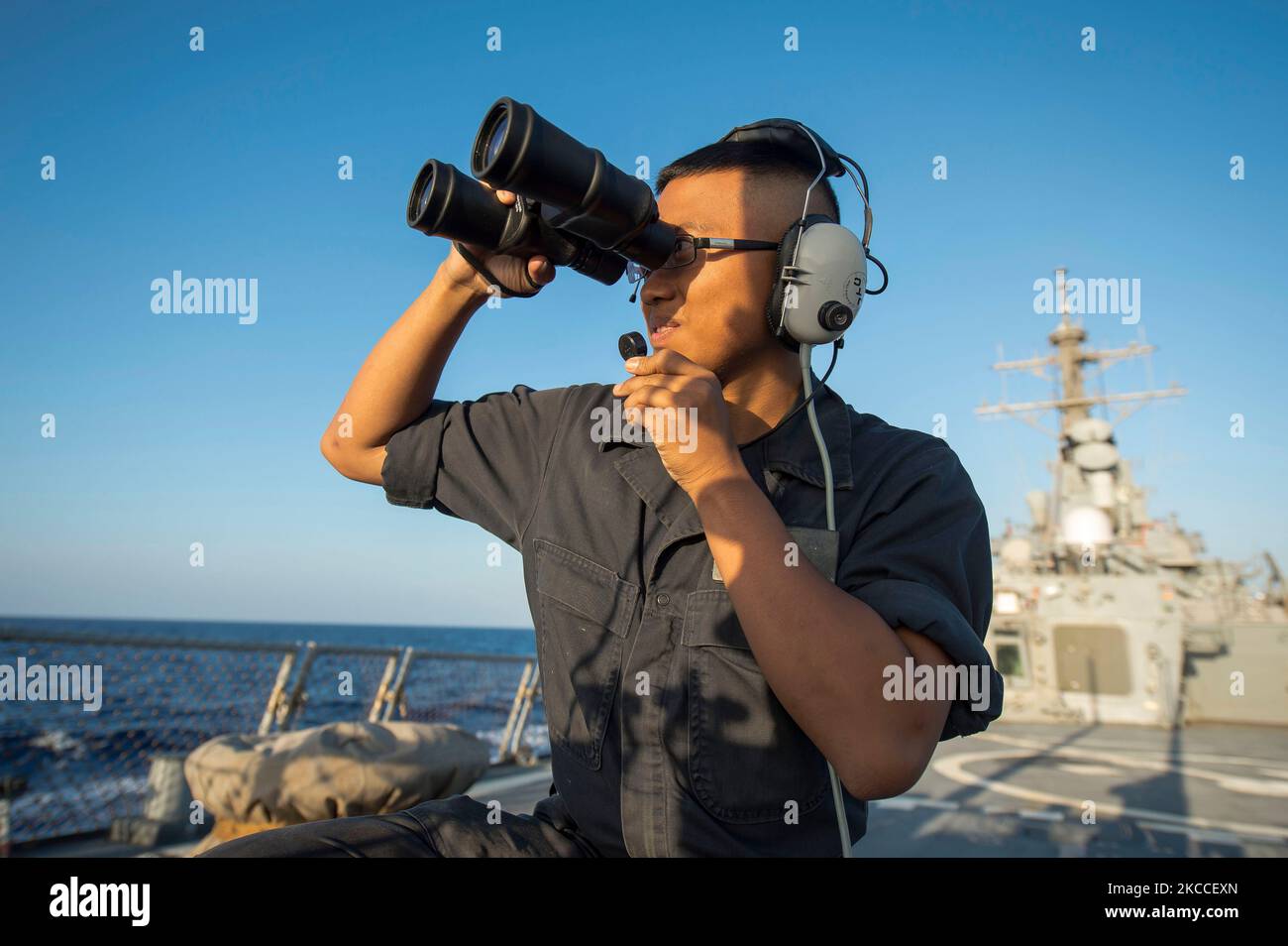 Seaman stands aft look-out watch aboard USS Ross. Stock Photo