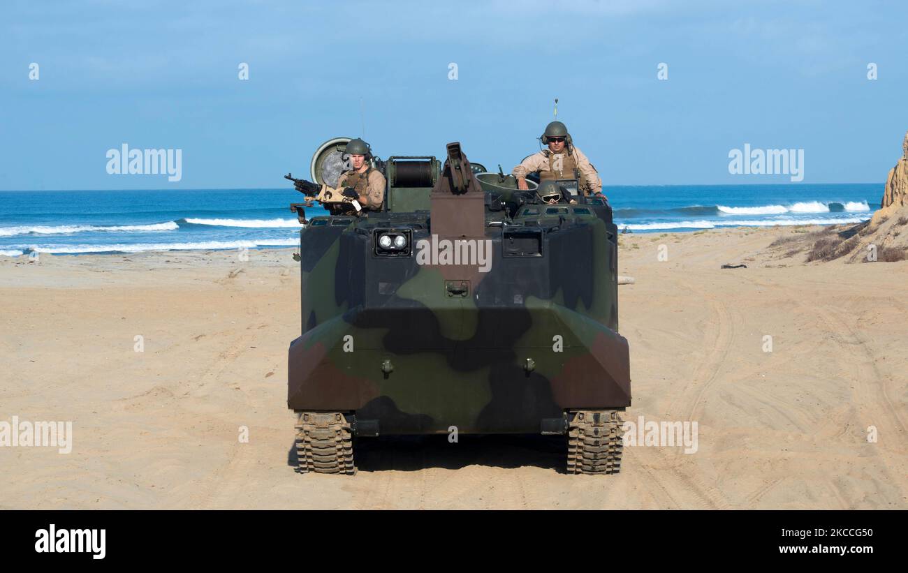 U.S. Marines drive an amphibious assault vehicle on the beach. Stock Photo