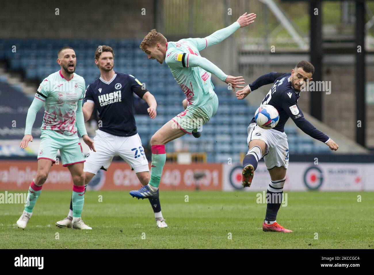 Mason Bennett of Millwall and Jay Fulton of Swansea City battle for the ball during the Sky Bet Championship match between Millwall and Swansea City at The Den, London, England on 10th April 2021. (Photo by Federico Maranesi/MI News/NurPhoto) Stock Photo