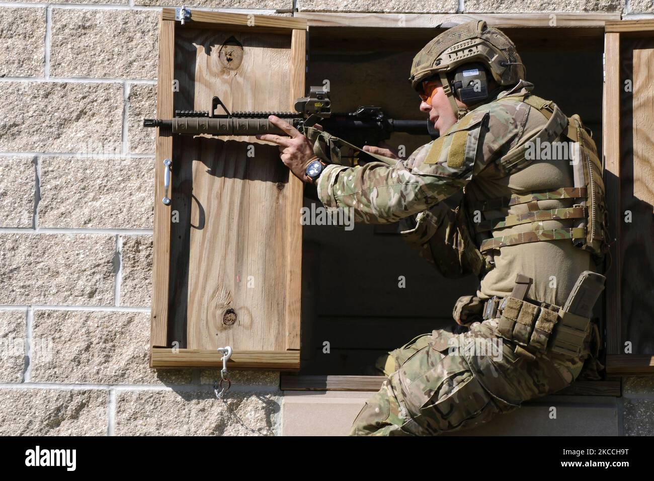 A Green Beret soldier fires a rifle. Stock Photo