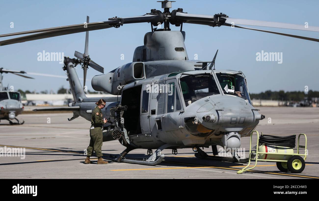 An aviation ordnance technician visually inspects a UH-1Y Venom. Stock Photo