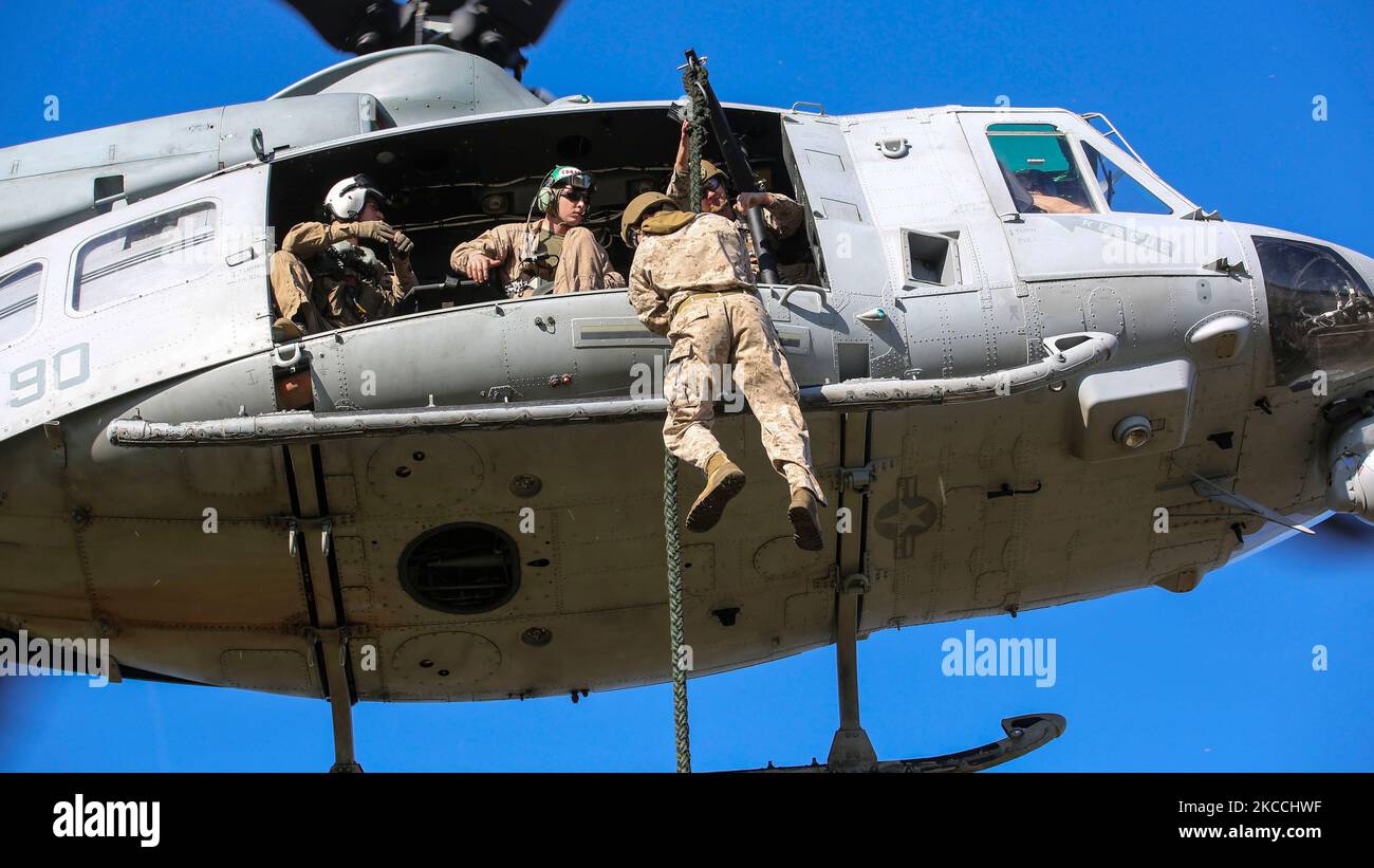 A U.S. Marine student conducts a fast-rope descent out of a UH-1Y Venom helicopter. Stock Photo