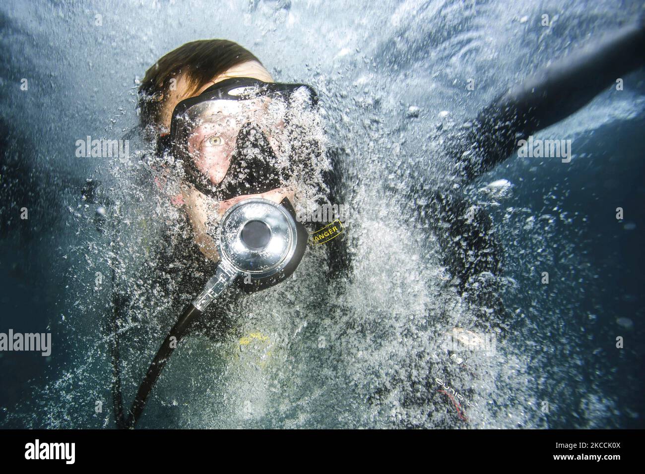 U.S. Navy Petty Officer enters the water off the coast of Guantanamo Bay, Cuba. Stock Photo