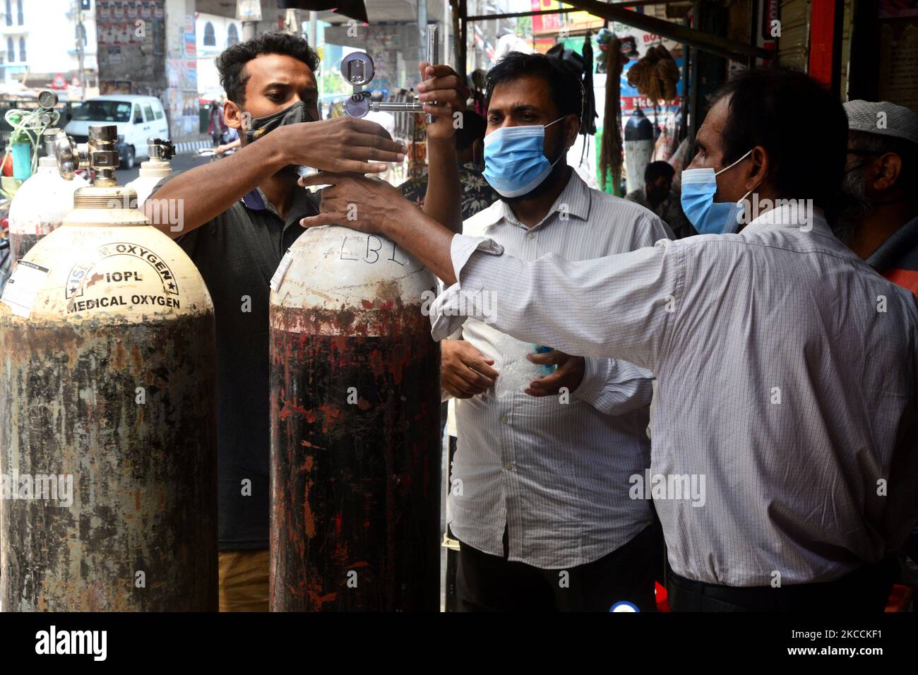 A worker set up oxygen cylinder at a store as cylinders demand rise up ...