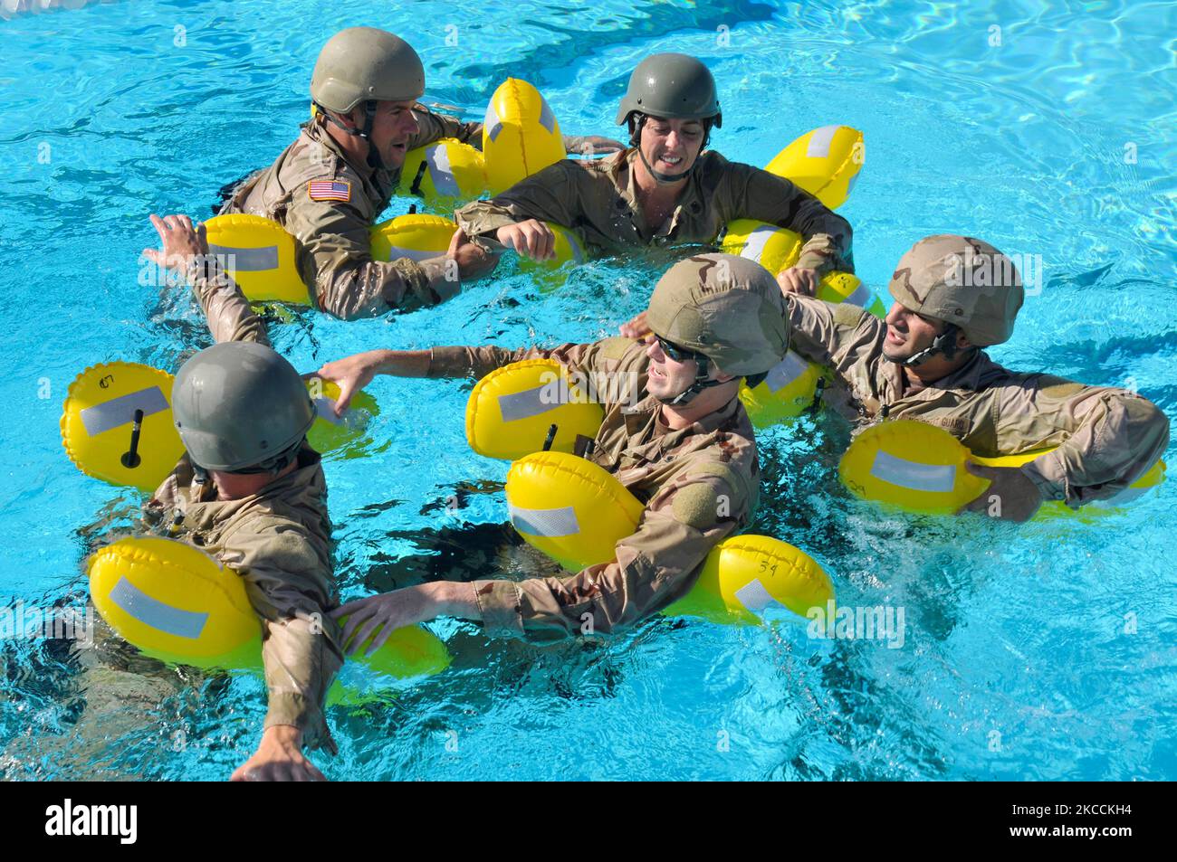 U.S. Coast Guardsmen form a human raft during water survival training. Stock Photo