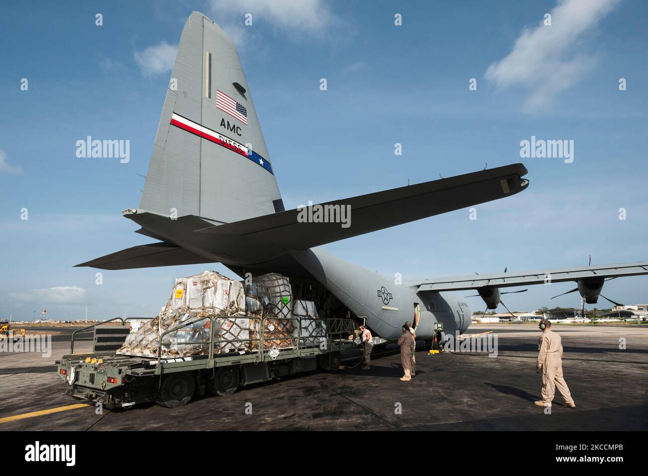 Aerial porters load supplies on a C-130 aircraft. Stock Photo