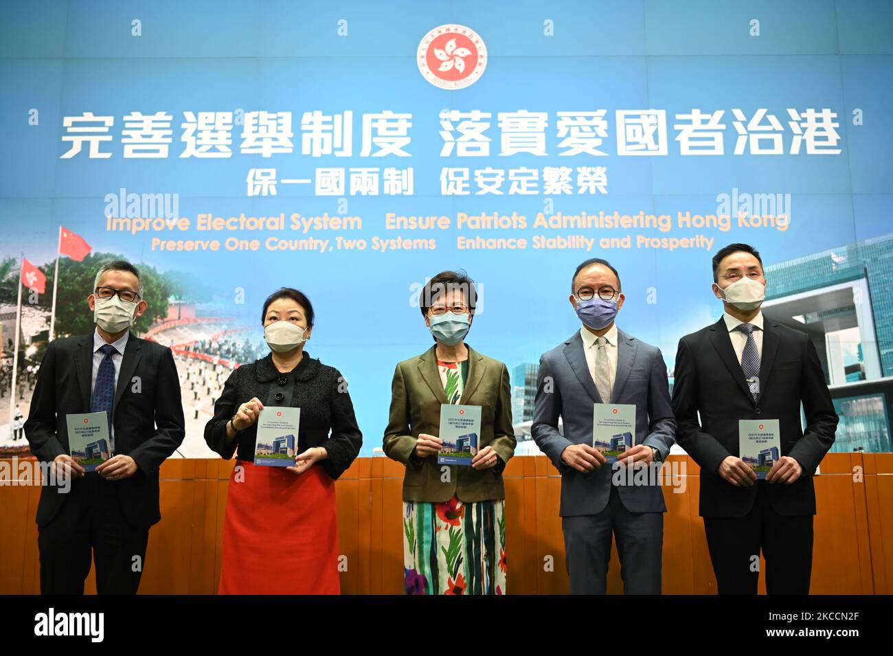 From Left to Right Ms Llewellyn Mui, Acting Officer(Special Duties), Ms Teresa Cheng, Secretary for Justice, Mrs Carrie Lam, Chief Executive of Hong Kong, Mr Eric Tsang, Secretary for constitution and mainland affairs, Mr Roy Tang, permanent secretary for Constitutional and Mainland affairs hols up booklet during a press conference on 'Improving Electoral System' in Hong Kong, China, on April 13, 2021. The government is formally proposing to make it a crime for people to urge others to cast blank or spoiled ballots, or not vote at all, as it unveiled a host of bills to amend local laws in line Stock Photo