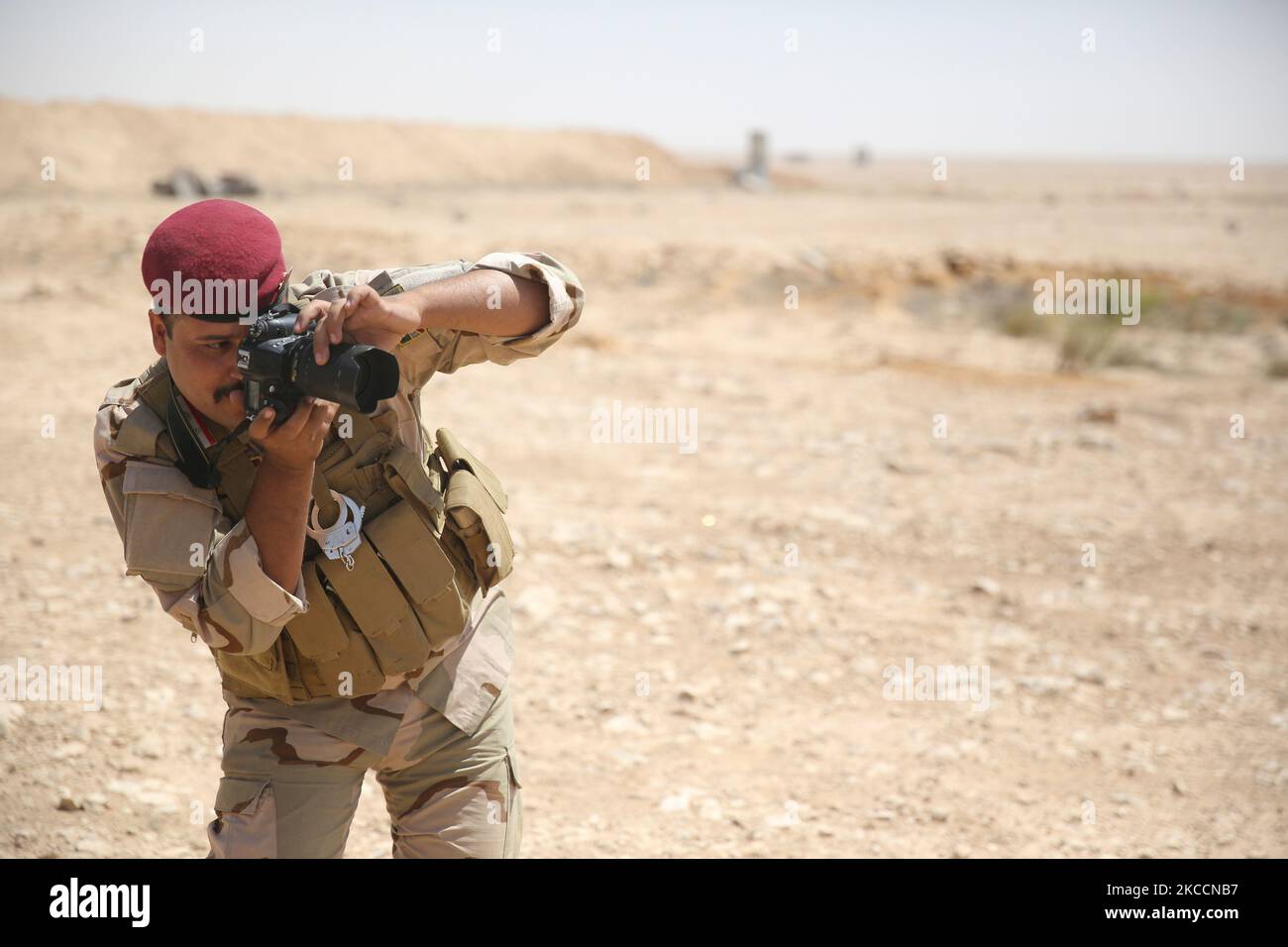Pule Using His Camera An Iraqi security forces soldier practices using his camera during ...