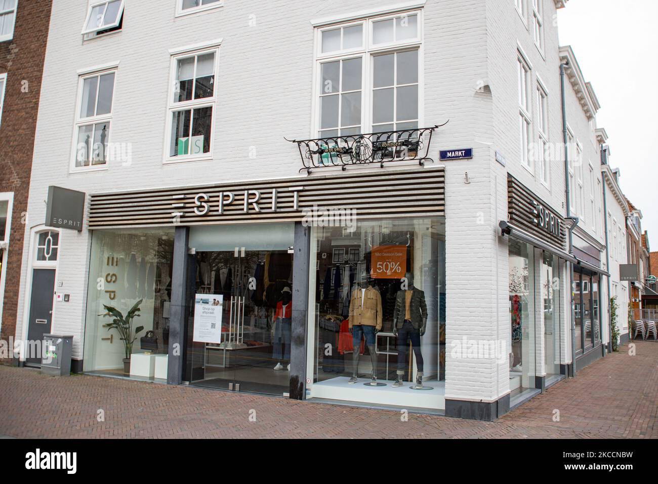 Esprit shop with the logo sign on the facade of the building and a billboard as seen closed in the Dutch city Middelburg. Esprit Holdings Limited is a publicly owned manufacturer of clothing, footwear accessories, jewelry and housewares under the Esprit label with 429 retail stores worldwide. Due to the Covid-19 Coronavirus pandemic and the lockdown measures applied, shopping to non-essential shops is allowed only with an appointment. Middelburg, Netherlands on Apri 11, 2021 (Photo by Nicolas Economou/NurPhoto) Stock Photo