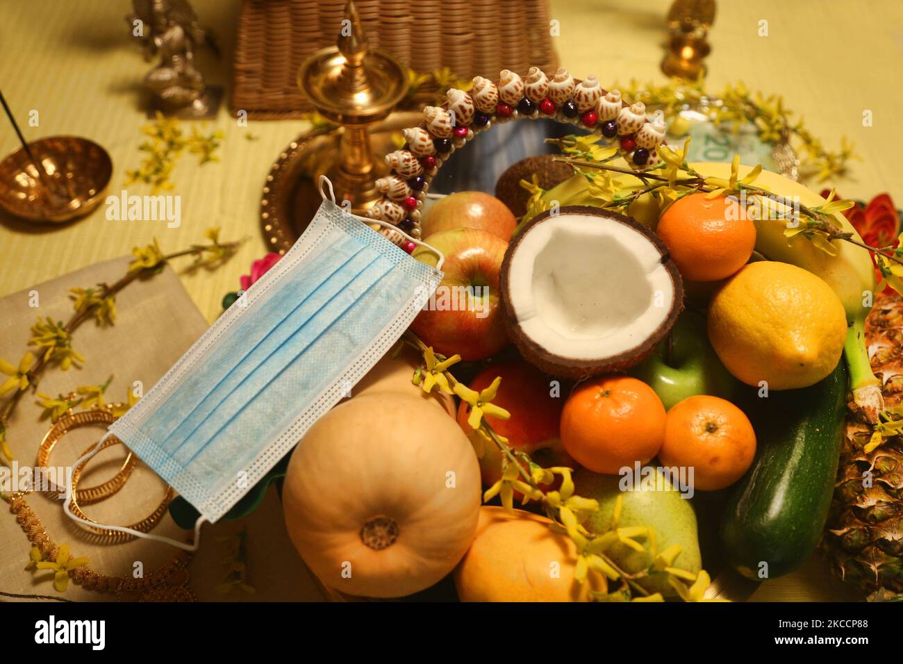 Face mask by a traditional Vishu kani (Vishukani) setting seen ...